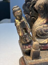 A Chinese gilt-lacquered wooden Bodhisattva and attendants on a throne, Qing