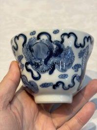A Chinese blue and white 'Buddhist Lion' teapot, covered bowl and a saucer, various marks, 19th C.