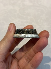 A small Chinese metal-alloy square mirror with relief design, Tang