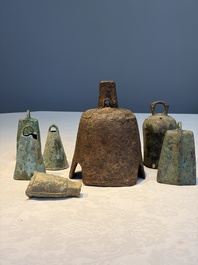 Seven various Chinese bronze and cast-iron bells, Han and later