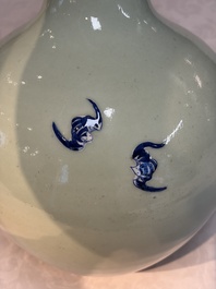 A Chinese blue and white celadon-ground 'Sanxing' bottle vase with relief design, 19th C.