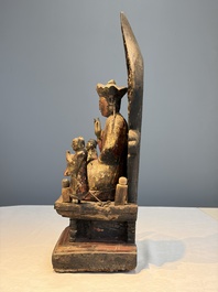 A Chinese gilt-lacquered wooden Bodhisattva and attendants on a throne, Qing