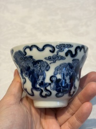 A Chinese blue and white 'Buddhist Lion' teapot, covered bowl and a saucer, various marks, 19th C.