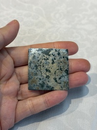 A small Chinese metal-alloy square mirror with relief design, Tang