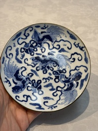 A Chinese blue and white 'Buddhist Lion' teapot, covered bowl and a saucer, various marks, 19th C.