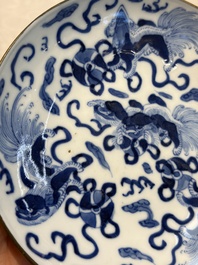 A Chinese blue and white 'Buddhist Lion' teapot, covered bowl and a saucer, various marks, 19th C.