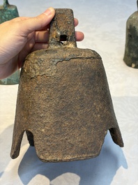 Seven various Chinese bronze and cast-iron bells, Han and later