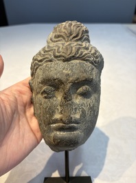 A Gandhara grey schist relief fragment of a Bodhisattva head, 3rd/4th C.