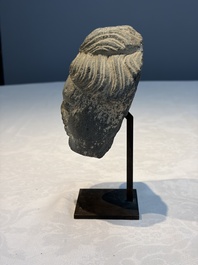 A Gandhara grey schist relief fragment of a Bodhisattva head, 3rd/4th C.