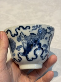 A Chinese blue and white 'Buddhist Lion' teapot, covered bowl and a saucer, various marks, 19th C.
