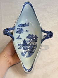 A pair of Chinese blue and white handled sauce boats and stands with pagodas along a river, Qianlong