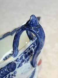 A pair of Chinese blue and white handled sauce boats and stands with pagodas along a river, Qianlong
