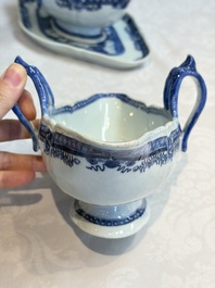 A pair of Chinese blue and white handled sauce boats and stands with pagodas along a river, Qianlong