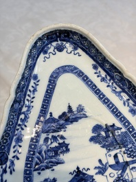 A pair of Chinese blue and white handled sauce boats and stands with pagodas along a river, Qianlong