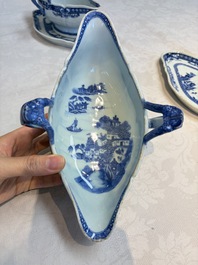 A pair of Chinese blue and white handled sauce boats and stands with pagodas along a river, Qianlong