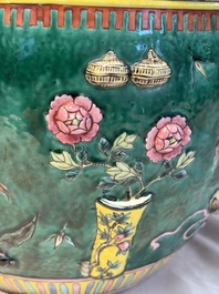 A Chinese famille rose green-ground 'Antiquities' fish bowl or jardini&egrave;re with applied relief design, 19th C.
