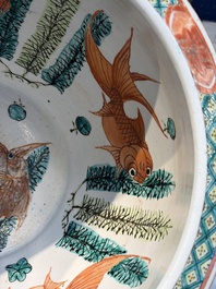 A Chinese famille rose green-ground 'Antiquities' fish bowl or jardini&egrave;re with applied relief design, 19th C.
