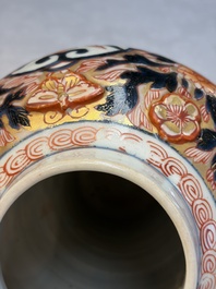 A pair of Japanese Imari baluster vases and covers on wooden stands, Edo, 18th C.