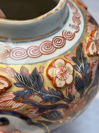 A pair of Japanese Imari baluster vases and covers on wooden stands, Edo, 18th C.