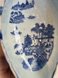 A pair of Chinese blue and white handled sauce boats and stands with pagodas along a river, Qianlong