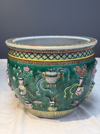 A Chinese famille rose green-ground 'Antiquities' fish bowl or jardini&egrave;re with applied relief design, 19th C.