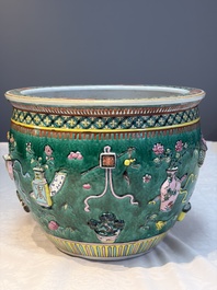 A Chinese famille rose green-ground 'Antiquities' fish bowl or jardini&egrave;re with applied relief design, 19th C.