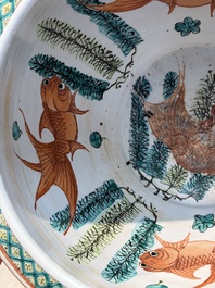 A Chinese famille rose green-ground 'Antiquities' fish bowl or jardini&egrave;re with applied relief design, 19th C.