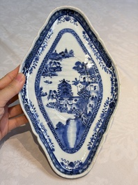 A pair of Chinese blue and white handled sauce boats and stands with pagodas along a river, Qianlong