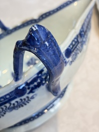 A pair of Chinese blue and white handled sauce boats and stands with pagodas along a river, Qianlong