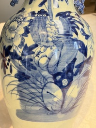 Two Chinese blue and white celadon-ground vases and a blue and white vase, on wooden stands, 19th C.