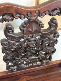 A pair of Chinese carved hongmu armchairs, 19th C.