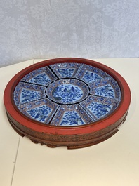 A Chinese enamelled Yixing stoneware nine-piece 'peonies' sweetmeat set on a Southeast Asian lacquer tray, 19th C.