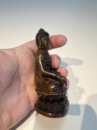 Three Tibetan bronze ritual bells and a bronze Buddha, 19th C.