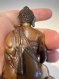 Three Tibetan bronze ritual bells and a bronze Buddha, 19th C.