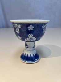 A Chinese blue and white 'Prunus on Cracked Ice' stem bowl, Kangxi