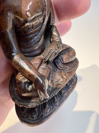 Three Tibetan bronze ritual bells and a bronze Buddha, 19th C.