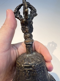 Three Tibetan bronze ritual bells and a bronze Buddha, 19th C.