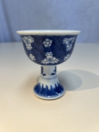 A Chinese blue and white 'Prunus on Cracked Ice' stem bowl, Kangxi