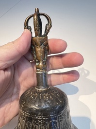 Three Tibetan bronze ritual bells and a bronze Buddha, 19th C.