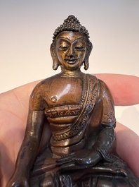 Three Tibetan bronze ritual bells and a bronze Buddha, 19th C.