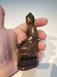 Three Tibetan bronze ritual bells and a bronze Buddha, 19th C.