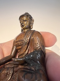 Three Tibetan bronze ritual bells and a bronze Buddha, 19th C.