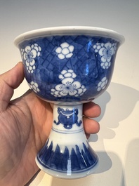 A Chinese blue and white 'Prunus on Cracked Ice' stem bowl, Kangxi