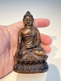 Three Tibetan bronze ritual bells and a bronze Buddha, 19th C.