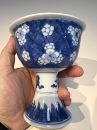A Chinese blue and white 'Prunus on Cracked Ice' stem bowl, Kangxi