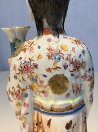 A Chinese famille rose candle holder in the shape of a court lady holding a 'Gu' vase, Qianlong