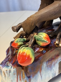 A Chinese polychrome-glazed Shiwan stoneware 'Monkey and Peach' group, signed, 20th C.