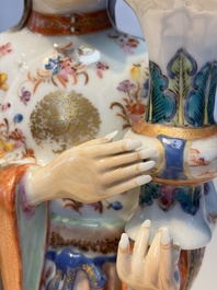 A Chinese famille rose candle holder in the shape of a court lady holding a 'Gu' vase, Qianlong