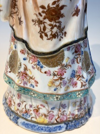 A Chinese famille rose candle holder in the shape of a court lady holding a 'Gu' vase, Qianlong