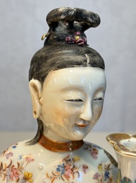 A Chinese famille rose candle holder in the shape of a court lady holding a 'Gu' vase, Qianlong